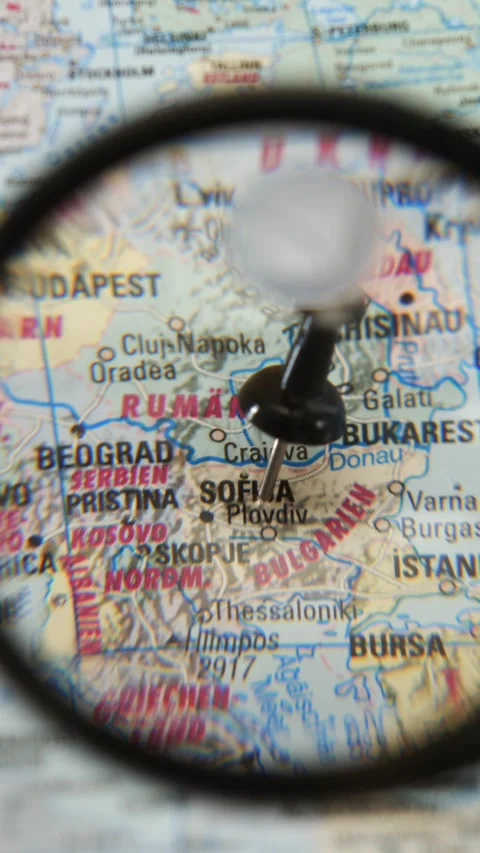 Exploring a map with a magnifying glass Stock Footage 345722455