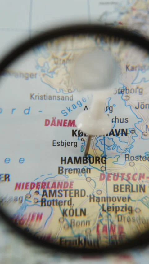 Exploring a map with a magnifying glass over a specific location Stock Footage 342435426