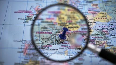 Exploring a map of Nice through a magnifying glass in daylight Stock Photos