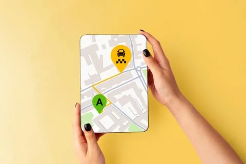Exploring a map for taxi route on a device in a city area with marked locations Stock Photos