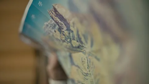 Exploring Mountain Regions with a Paper Map for Planning Alpine Hiking Vídeos de archivo 331166099