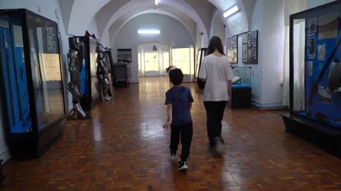 Exploring a museum with historical displays and armor in a quiet setting Видео 340448056