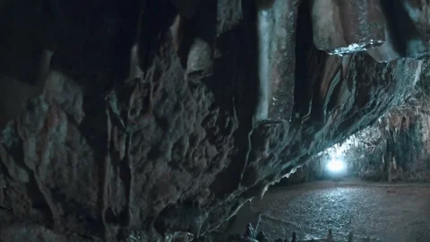Exploring a Mysterious Underground Cave with Shimmering Formations Stock Footage 328306968
