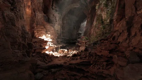Exploring the mysterious underground cavern with light filtering from above Stock Footage 291859892