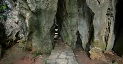 Exploring the narrow passage at impressive Shilin Stone Forest, POV shot 库存影片 329472319