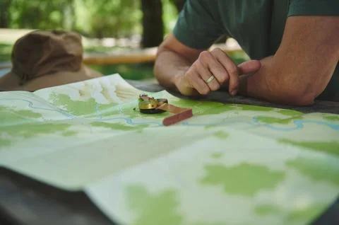 Exploring Nature With Map and Compass on a Wooden Table Outdoors Stock Photos