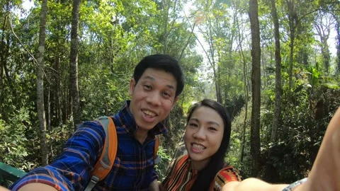 Exploring Nature Together in a Lush Forest Stock Footage 314592306
