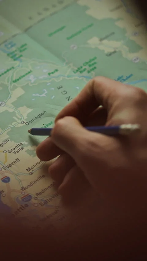 Exploring new adventures with a detailed map and handwritten notes in hand Stock Footage 331570631