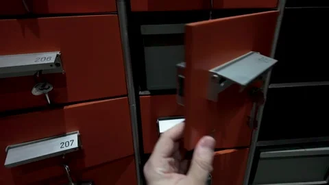 Exploring a package locker system to retrieve a delivery in a busy urban ar.. Stock Footage 335879361