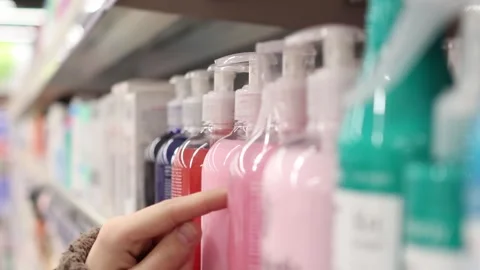 Exploring personal care options at a local store in a vibrant aisle 스톡 동영상 296147816