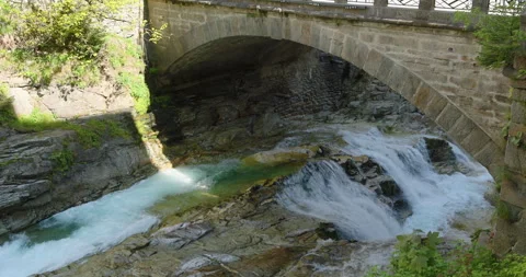Exploring the picturesque river and bridge in a serene natural landscape Video stock 314083195