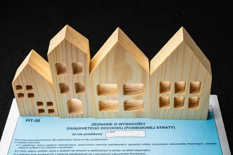 Exploring Polish PIT Tax Forms with Artistic Wooden House Models at Home Stock Photos