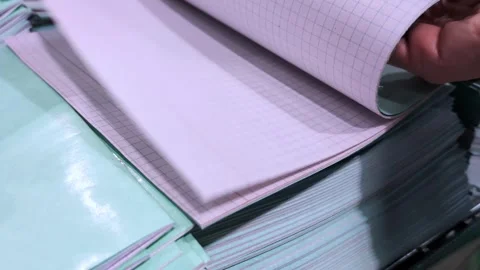 Exploring the process of selecting high-quality graph paper in a bustling Stock Footage 314093321