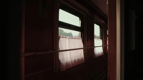 Exploring the quiet interior of a vintage train carriage with soft morning light Stock Footage 318289379