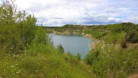 Exploring a quiet landscape with water surrounded by trees and hills Stock-Footage 340448321