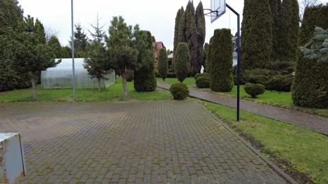 Exploring a quiet outdoor space with paths and trees in a park setting Vídeo Stock 337124073