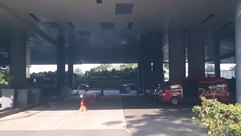Exploring the Quiet Underpass of a Jakarta Mall Parking Lot Stock Footage 236932321