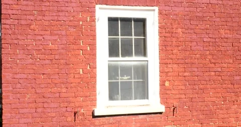 Exploring a Red Brick Building With a White Window Stock Footage 262401012