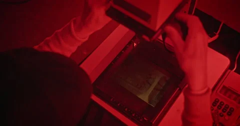 Exploring Red Light Photography Techniques in a WellEquipped Darkroom Setup Stock-Footage 305087933