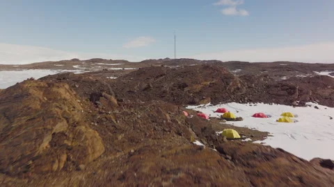 Exploring the Remote Antarctica Camp Base Surrounded by Snow and Rugged Terrain Stock Footage 288166365