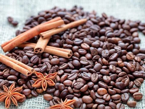 Exploring the rich aromas of roasted coffee beans and spices on a textured .. Stock Photos