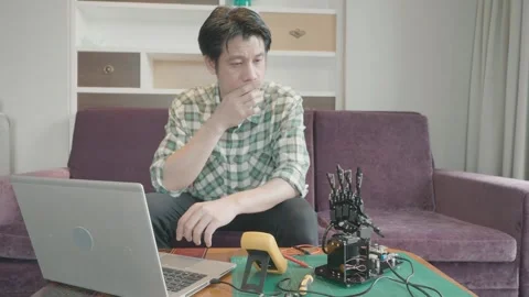 Exploring Robotics: A Man Engages with Technology at Home Stock Footage 319415121