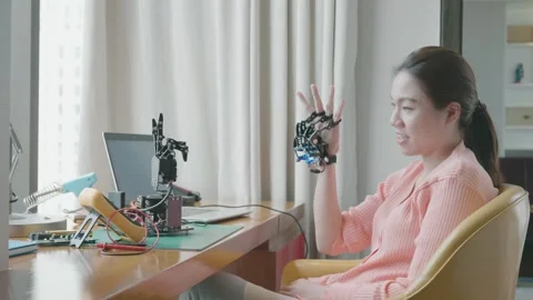 Exploring Robotics: A Woman Interacts with Innovative Technology Stock Footage 316074018