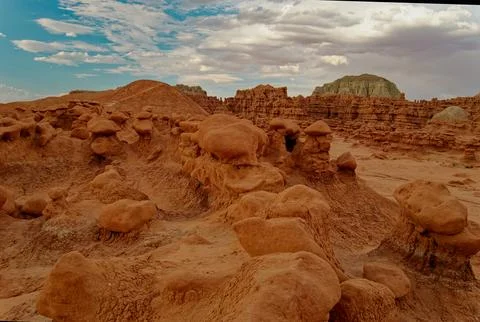Exploring rock formations in the desert under a cloudy sky in the afternoon Stock Photos