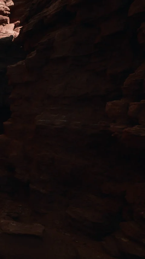 Exploring a rocky canyon with layers of red stone and shadows Stock Footage 346755005