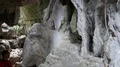 Exploring a rocky cave formation with lianas and stoned coral fossil in Flores 4k or 4k+ Resolution