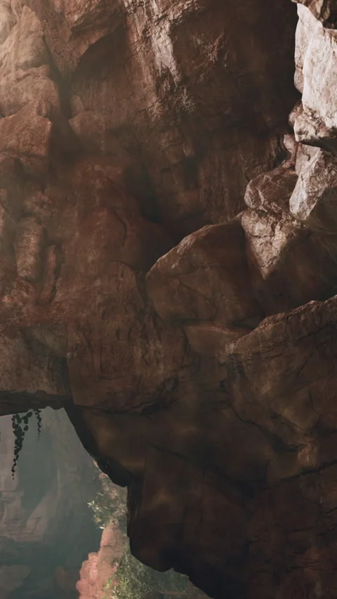 Exploring a rocky cave with natural light shining through the opening Stock Footage 340281011