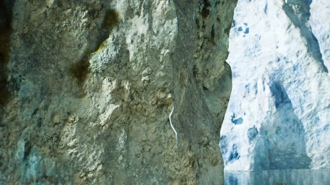 Exploring a rocky cave with water reflection in a natural landscape Stock Footage 344876911