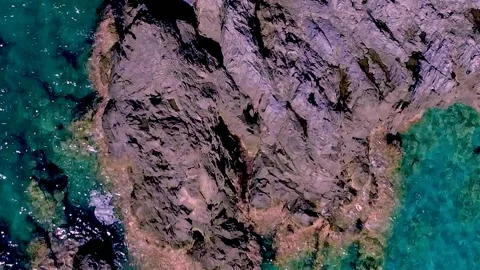 Exploring Rocky Coastline and Clear Waters at Midday on a Sunny Day Stock Footage 317765941