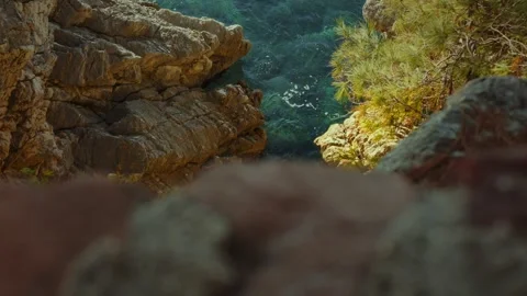Exploring rocky coastline with clear blue water on a sunny day in the great Stock Footage 313731492