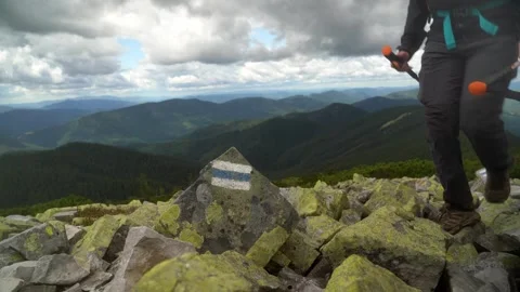 Exploring rocky mountain terrain with stunning views of green valleys Video stock 316763326