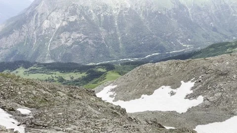 Exploring Rocky Terrain and Lush Valleys in the Mountains During Summer Stock Footage 304218709