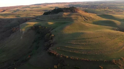 Exploring rolling hills at sunset in a serene countryside area Stock-Footage 320341041