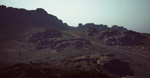 Exploring rugged mountain terrain at dusk with rocky formations in view イラスト素材