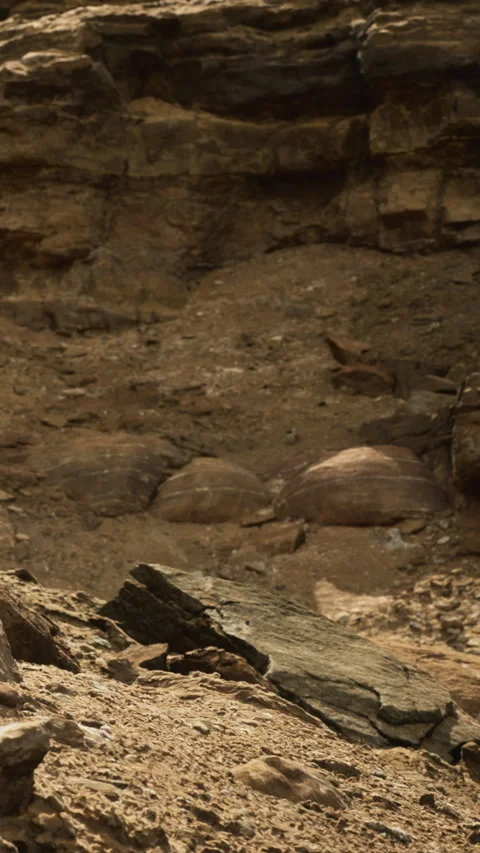 Exploring the rugged terrain of a desolate rocky landscape at dusk Stock Footage 334252250