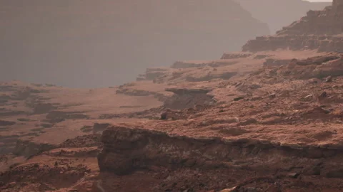 Exploring the Rugged Terrain of a Martian Landscape at Twilight Stock Footage 346688380