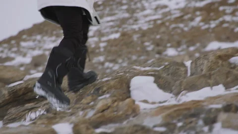 Exploring rugged terrain with snow boots in winter conditions Stock Footage 288195621