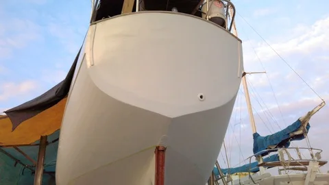 Exploring a rustic boat yard nestled at the water's edge of a sheltered bay Stock-Footage 107806099