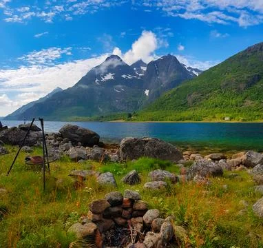 Exploring a scenic lakeside area with mountains in the background on a clea.. Stock Photos