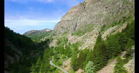 Exploring the serene mountain valley trail surrounded by lush greenery and Video stock 314083596