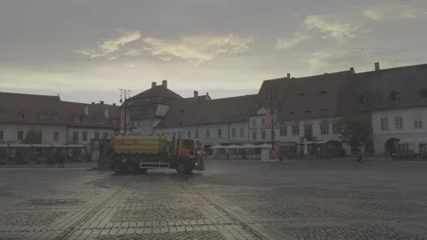Exploring Sibiu Lively City Square with washing car Urban Elegance and Rythm Stock Footage 255205280