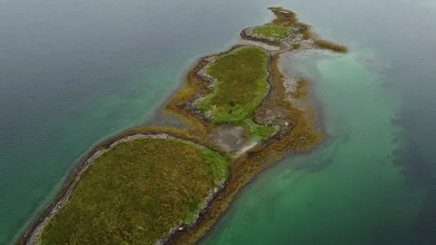 Exploring a small island in the ocean with lush green land and clear water Stock Footage 340503079
