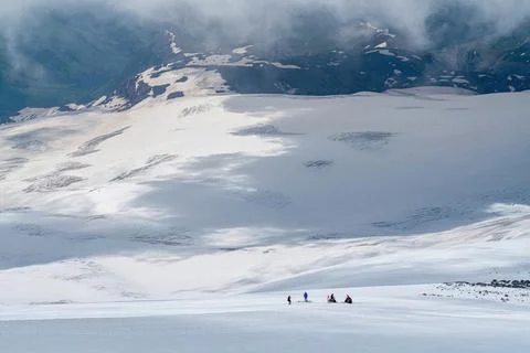 Exploring a snowy landscape with distant mountains Stock Photos