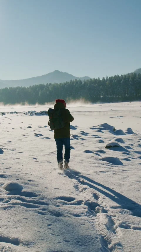Exploring a snowy landscape on a winter day in the mountains Stock Footage 312862748