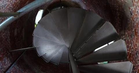 Exploring the spiral staircase inside a historic brick tower Stock Footage 281816952