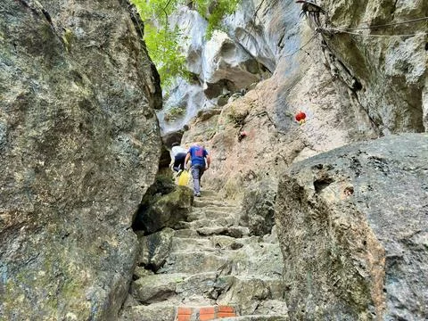 Exploring the stone stair path leading to the shrines inside the mountain cli Stock Photos